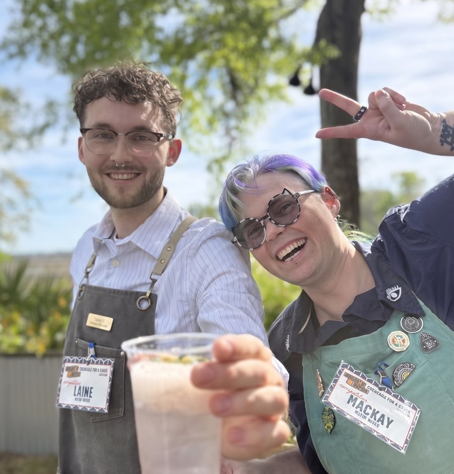 Laine offering a cocktail at a sunny outdoor event